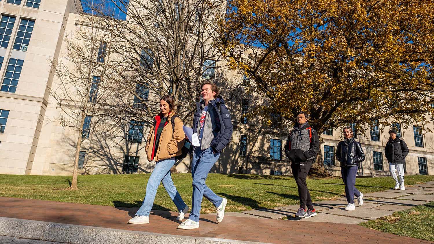 Students walking on campus near Neil Avenue and the Thompson Library