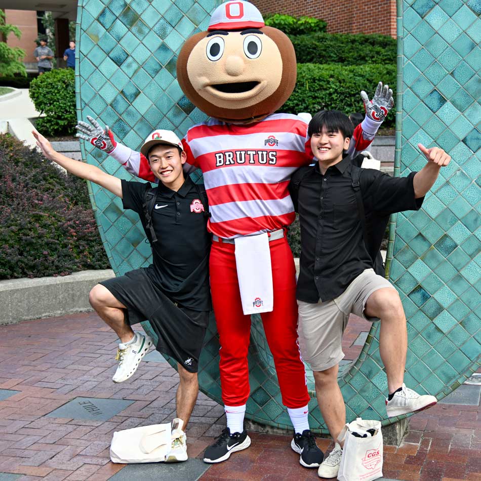 Two students cheering for the Buckeye football team in Ohio Stadium