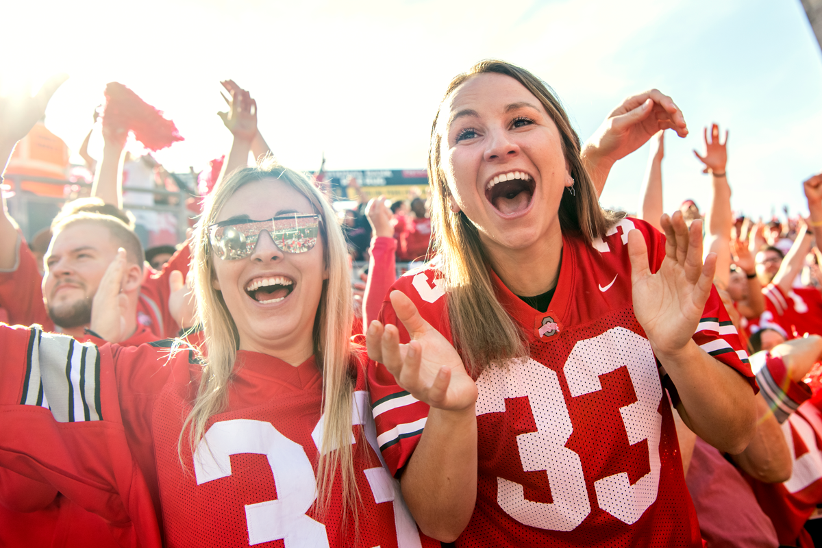 Two students cheering for the Buckeye football team in Ohio Stadium
