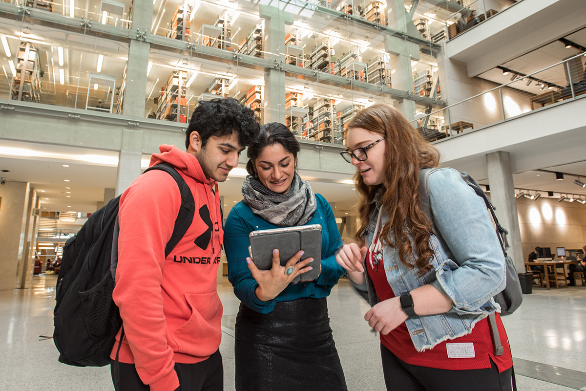 Two students cheering for the Buckeye football team in Ohio Stadium