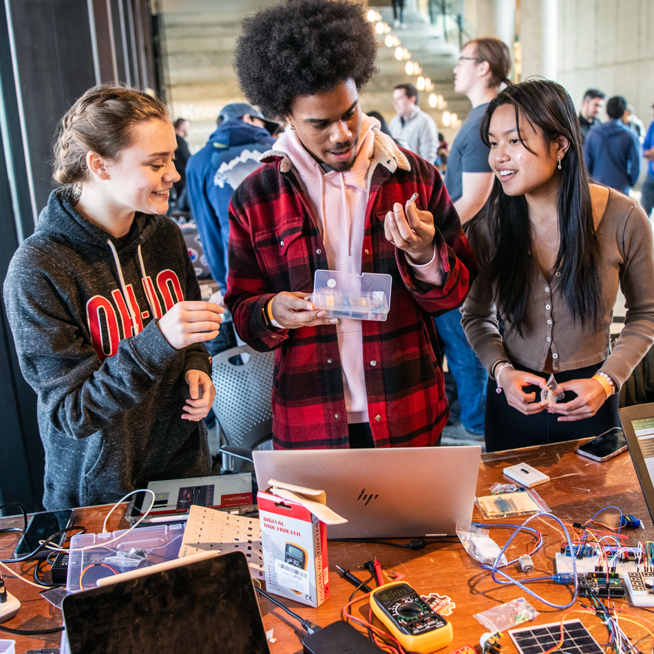 Three students participating at HackOHI/O, Ohio State’s largest annual hackathon