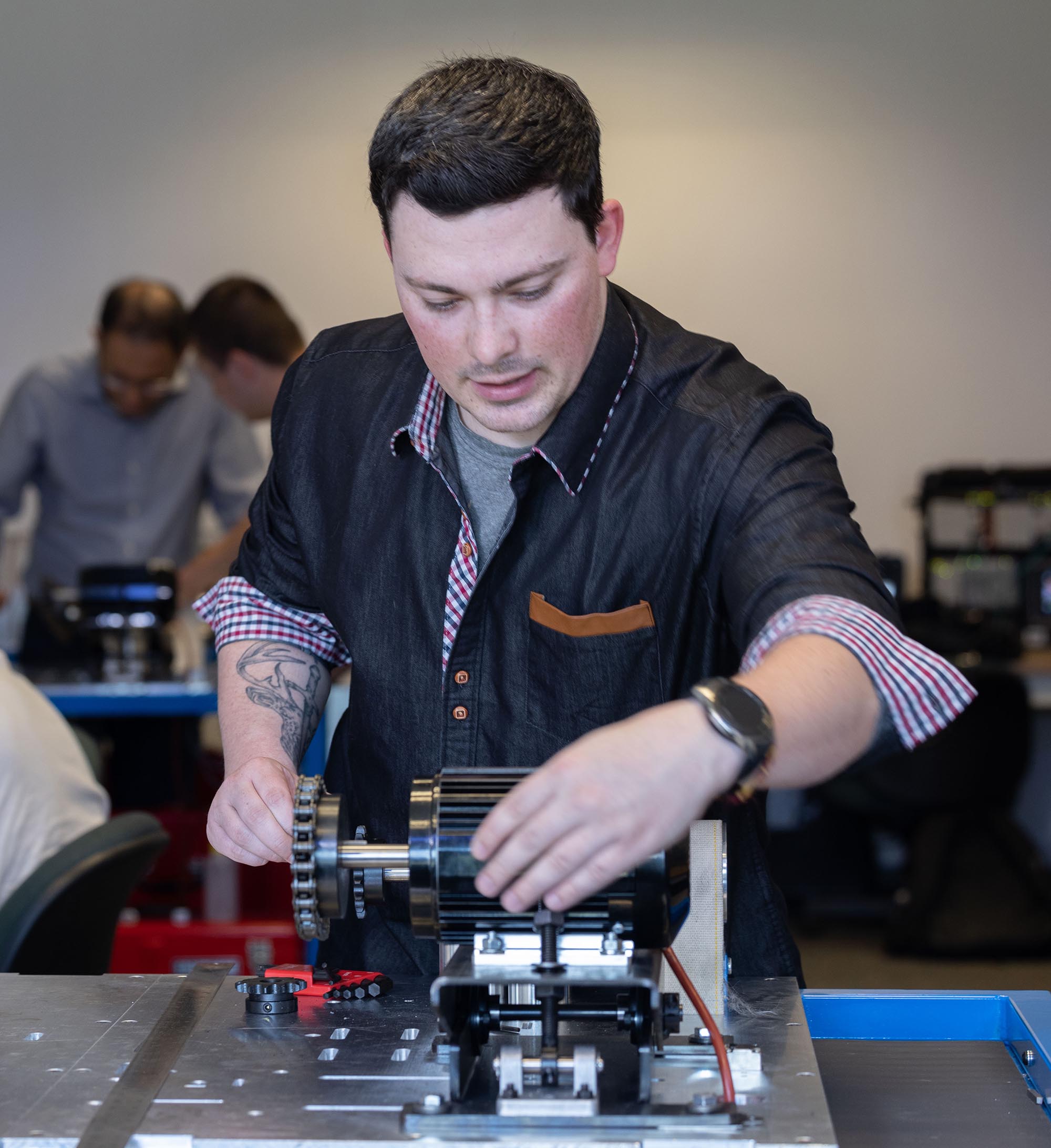 College student working hands on with small motor 