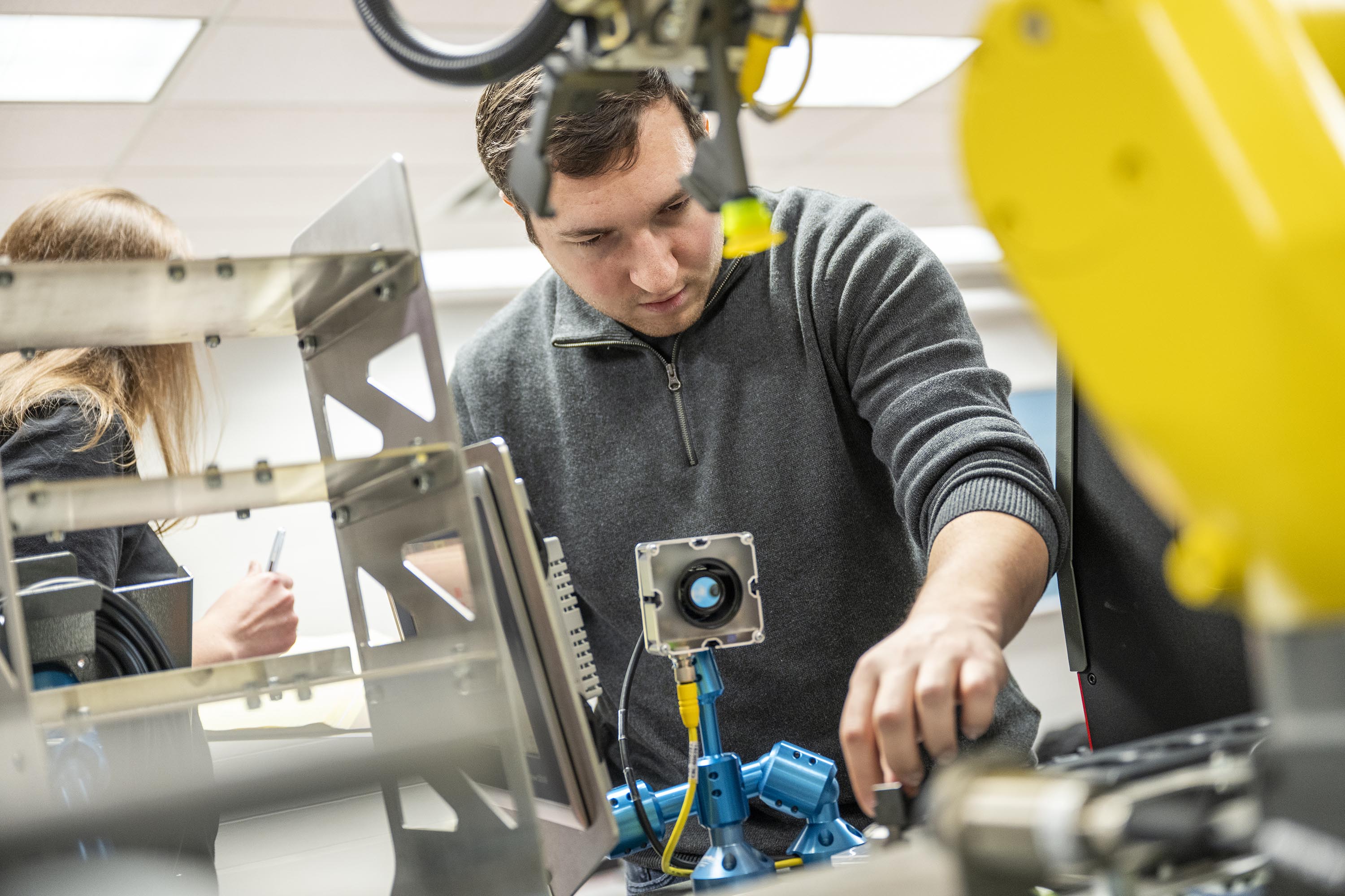 An engineering technology student working hands-on in a lab